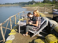 Kerstin and Hektor waiting for breakfast down at the Rapti river.